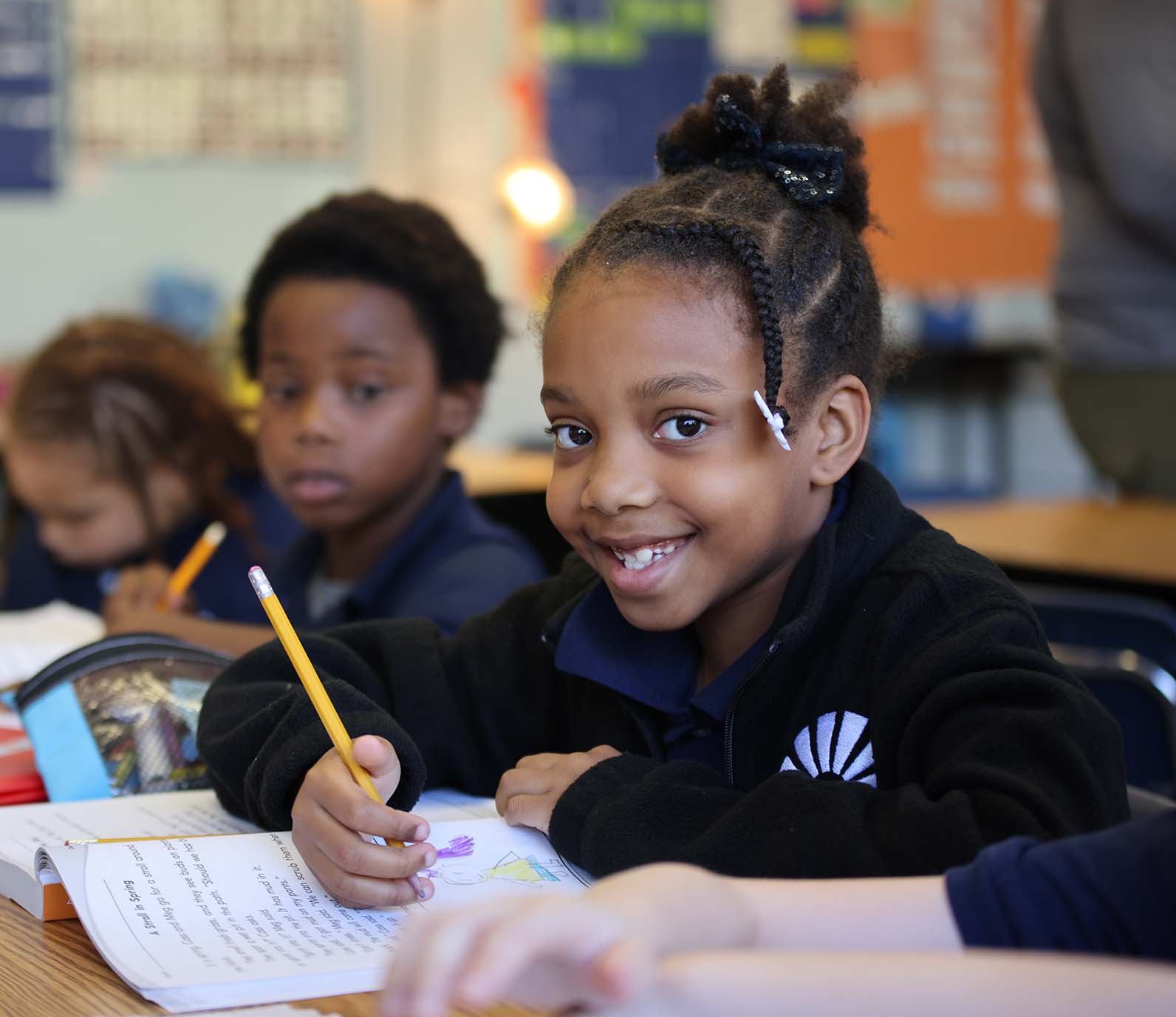 Horizon Science Academy Springfield North student wearing headphones uses a laptop in class