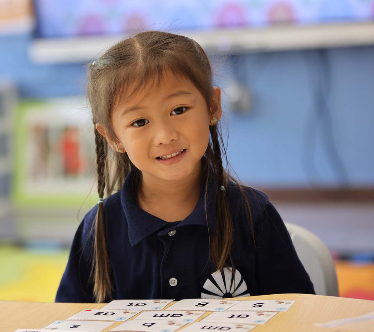 Student working on a notebook in a classroom.